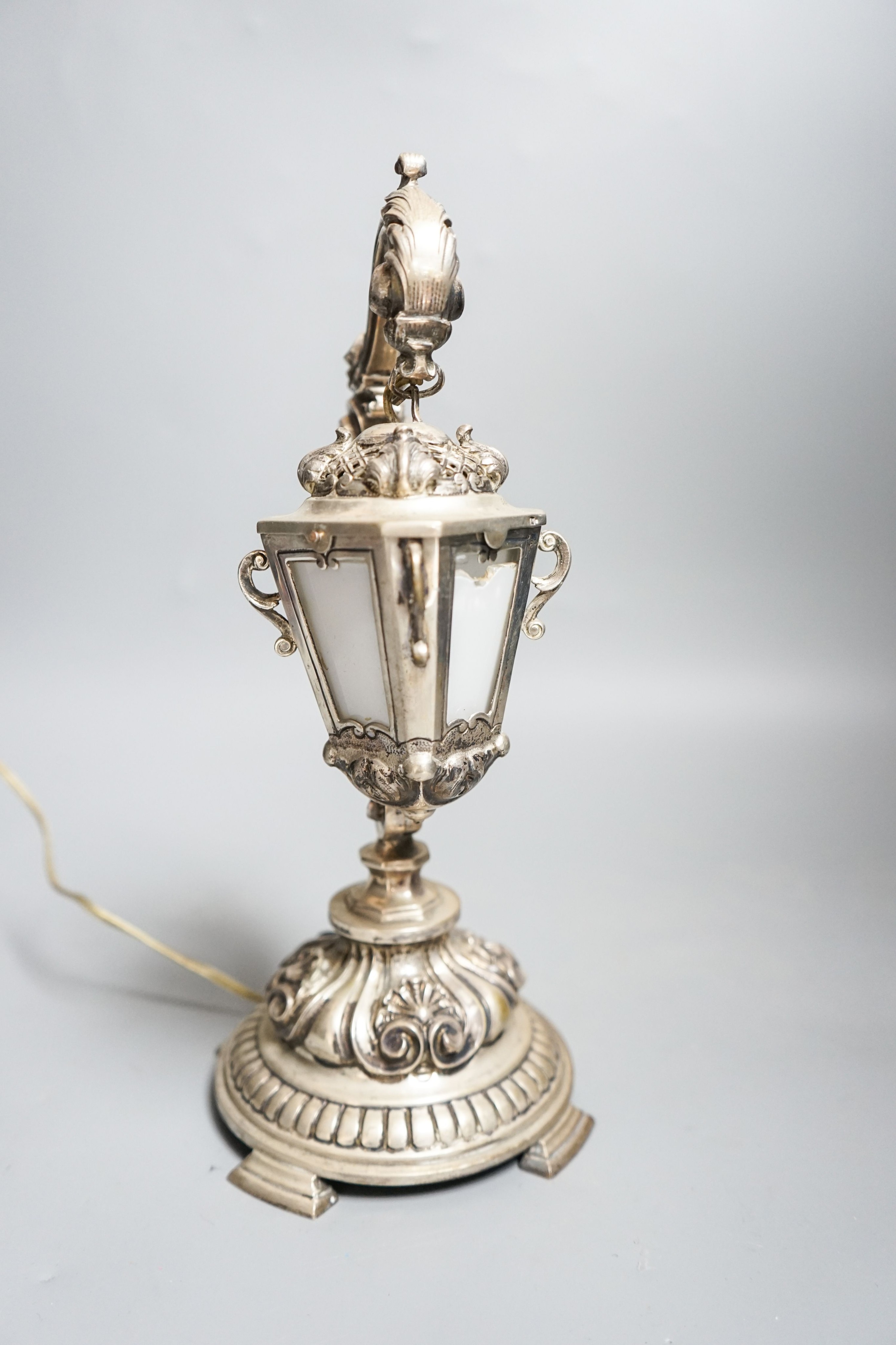 A Portuguese white metal table lamp modelled as a hanging lantern, height 28.1cm.